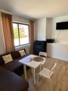 a living room with a couch and a table and chairs at Avalon Lux in Sunny Beach
