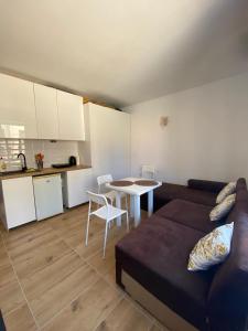 a living room with a couch and a table and a kitchen at Avalon Lux in Sunny Beach