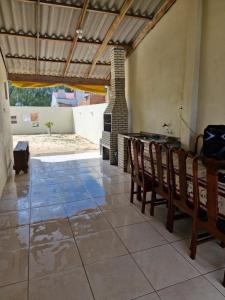 a room with a table and chairs and a fireplace at casa nova em imbé in Imbé