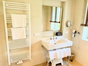 a white bathroom with a sink and a mirror at Villa Wattfuss in St. Peter-Ording +34 photos