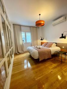 a bedroom with a bed and a table in it at The Zentral Suites & Apartments in Seville +154 photos