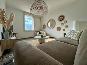 a living room with a couch and a table at Port Saint-Tropez in Saint-Tropez