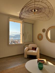 a living room with a chair and a window at Port Saint-Tropez in Saint-Tropez +19 photos