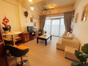 a living room with a couch and a table at Riverbank 904 in Kuching