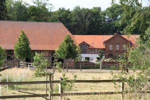 a large house with a fence in front of it at Ferienhaus Am Untergut in der Klingelstraße in Lüchow +13 photos