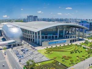 a large building in a city with a parking lot at My Happy Place in Nonthaburi