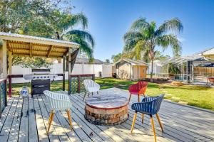a patio with a table and chairs on a wooden deck at Private Outdoor Oasis Luxe Palm Coast Retreat in Palm Coast