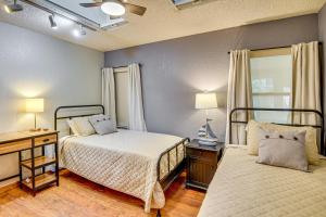 a bedroom with two beds and a desk with lamps at Private Outdoor Oasis Luxe Palm Coast Retreat in Palm Coast +16 photos