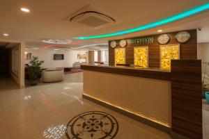 a hotel lobby with a reception counter and clocks at Armin Hotel in Amasya