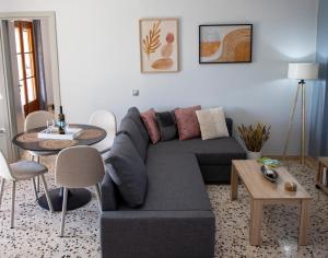 a living room with a couch and a table at Zefi's Aegina Apartment in Kapótidhes