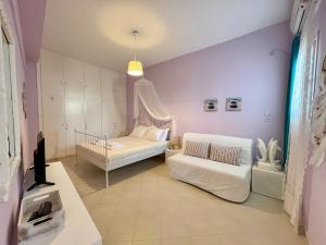 a small room with a bed and a couch at AIR, Oneiropagida, Aegina in Vathí +40 photos
