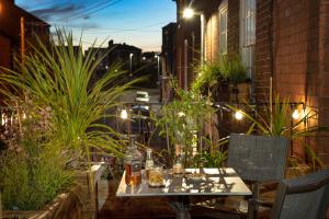 a table and chairs on a patio at night at Baldwin House in Stourport