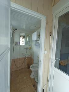 a bathroom with a toilet and a sink at Methea in Skopelos Town +51 photos