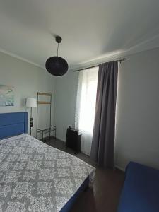 a bedroom with a bed and a window at Methea in Skopelos Town