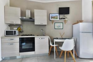 A kitchen or kitchenette at Villa Fantagali apt 502