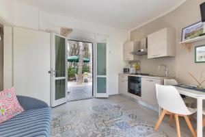A kitchen or kitchenette at Villa Fantagali apt 502