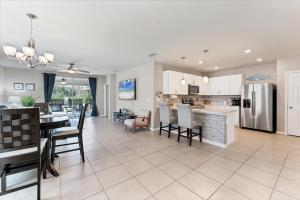 a kitchen and living room with a table and chairs at 25128 East Lenox in Punta Gorda