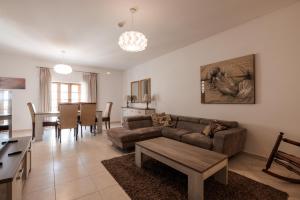 a living room with a couch and a table at Larger than usual 3BD Apartment in Sliema