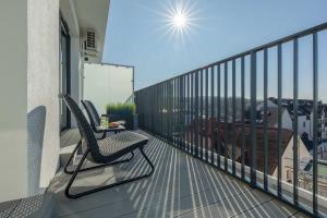 a balcony with a chair and a table on it at Baltic Waves Resort w Międzyzdrojach Blisko Plaży & Parking by Noclegi Renters in Międzyzdroje