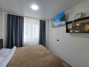 a bedroom with a bed and a window at MyApartment in Chişinău