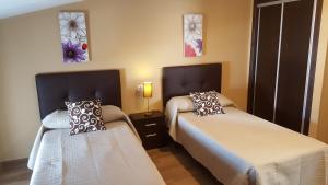 Łóżko lub łóżka w pokoju w obiekcie Hostal Málaga