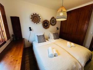 a bedroom with two beds and a chandelier at Corn House, São Pedro de Moel Sea View in Marinha Grande
