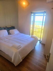 a bedroom with a large bed and a sliding glass door at Katakolo 2 Bedroom Apartment by MPS in Katakolon