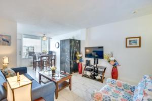 a living room with a couch and a tv at Daytona Beach Condo with Ocean-View Balcony! in Daytona Beach