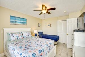 a bedroom with a bed and a ceiling fan at Daytona Beach Condo with Ocean-View Balcony! in Daytona Beach +19 photos