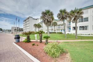 a large building with palm trees in front of it at Daytona Beach Condo with Ocean-View Balcony! in Daytona Beach