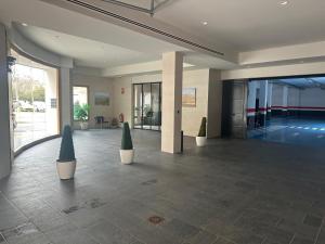 a lobby with two potted trees in a building at Yvacas 1A in Tudela