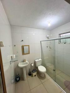 a bathroom with a toilet and a sink and a shower at Casa Temporada - Centro Guararema SP in Guararema +23 photos