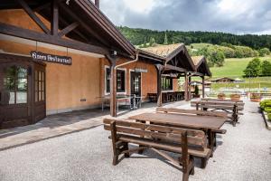 a group of benches outside of a building at Golf Hotel in Folgaria +31 photos
