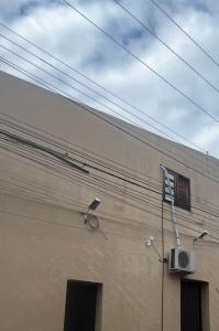 a building with a surveillance camera on the side of it at É de casa unidade 02 centro in Juazeiro do Norte