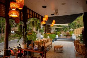 a lobby with a table and chairs and lights at Koh Kood Garden House in Ban Lak Uan