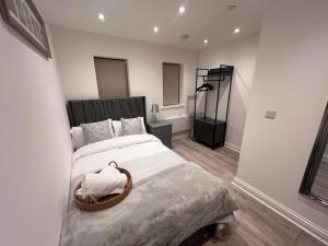 a bedroom with a large bed with a basket on it at Apartment 2 The Baileys Cwm Sleeps 2 in Cwm