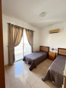 Ένα ή περισσότερα κρεβάτια σε δωμάτιο στο Diana Townhouse 2