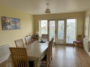 a dining room with a table and chairs at Number 1 Bank House in Schull