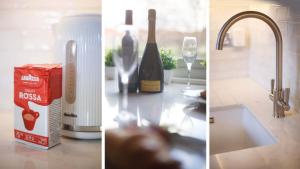 een aanrecht met een fles wijn en een wastafel bij Fishergate Bar Apartment sleeps 4 in York +18 foto's