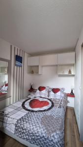 a bedroom with a large bed with red chairs at P2 au pied des Pistes La Joue du Loup in Le Dévoluy