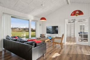a living room with a couch and a table at Lovely Holiday Home In Southern Jutland in Neder Lysabild