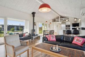 a living room with a couch and a table at Lovely Holiday Home In Southern Jutland in Neder Lysabild