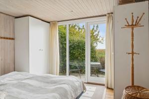 a bedroom with a bed and a large window at Holiday Home And Annex Surrounded By Nature in Ebberup