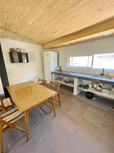 a kitchen with a table and a refrigerator and a table at Loft Jujuy 2 Departamento Céntrico in San Salvador de Jujuy +19 photos