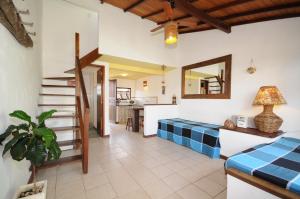 a bedroom with a bed and a staircase in a room at Búzios Casa 3 in Búzios