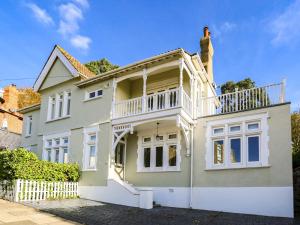 a white house with a balcony on top of it at Pass the Keys Large house Leigh Sea views in Southend-on-Sea