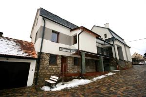 a house on a brick street with a building at Privat Kohut in Štrba