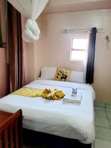 Postel nebo postele na pokoji v ubytování Sislink Hotel Nairobi