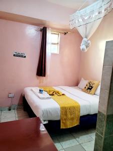 Postel nebo postele na pokoji v ubytování Sislink Hotel Nairobi