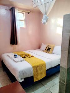 Postel nebo postele na pokoji v ubytování Sislink Hotel Nairobi + 17 fotografií